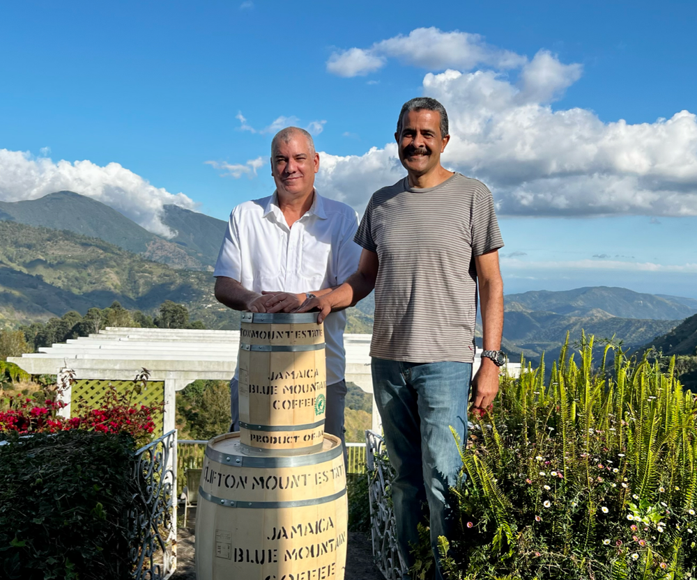 Sharp brothers at their coffee estate in Jamaica, Clifton Mount, holding barrels of Jamaica blue mountain coffee